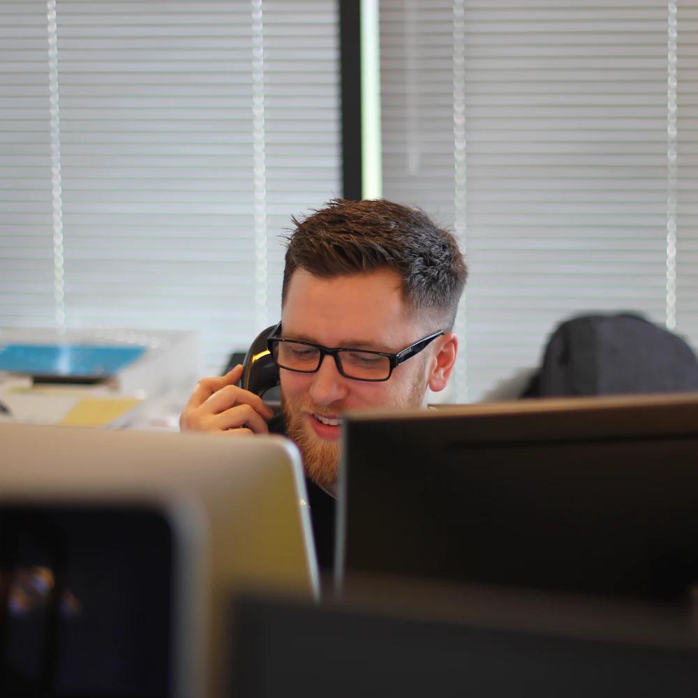 Office team member on a desk phone call